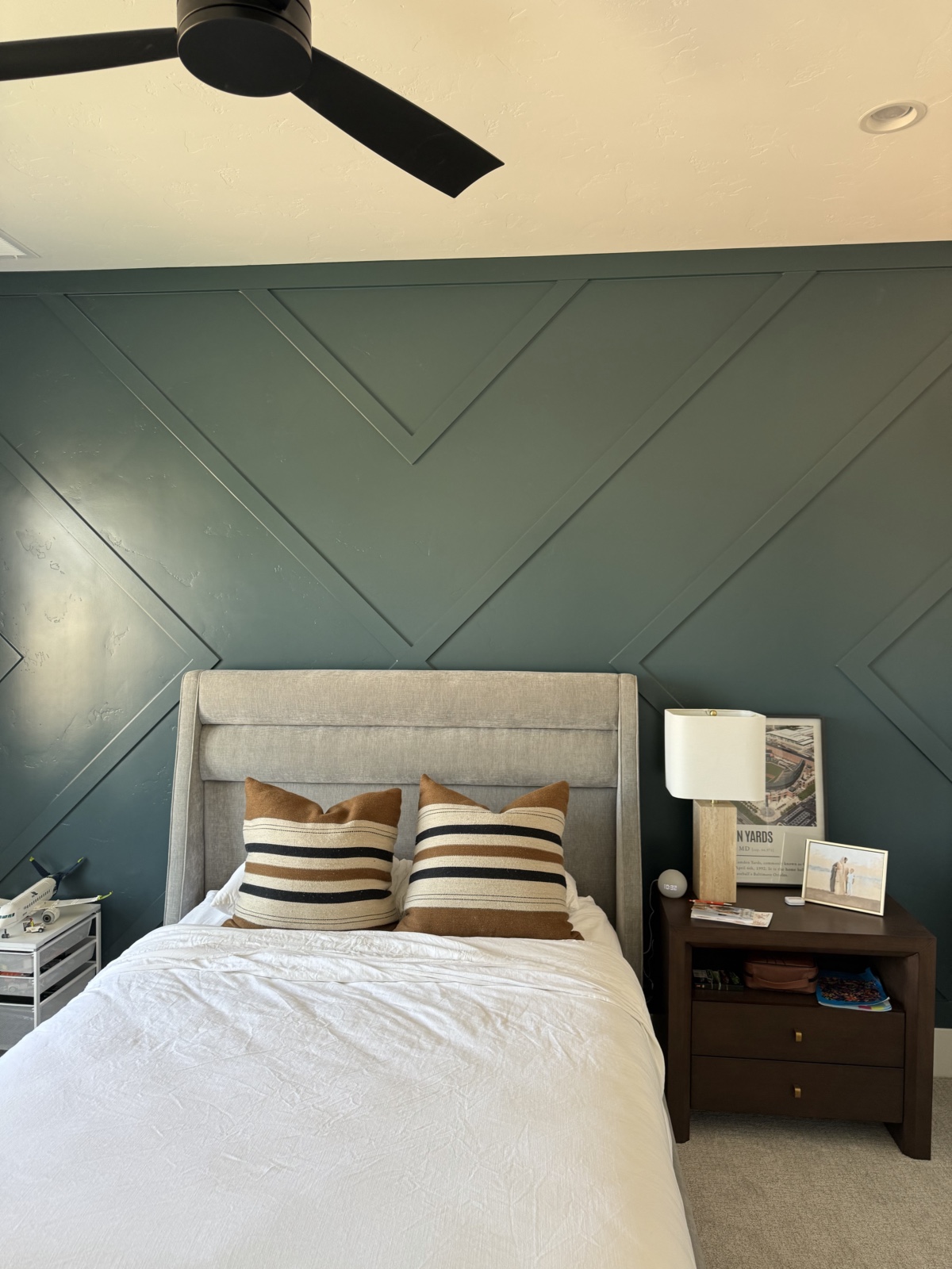 Bedroom with green chevron accent wall