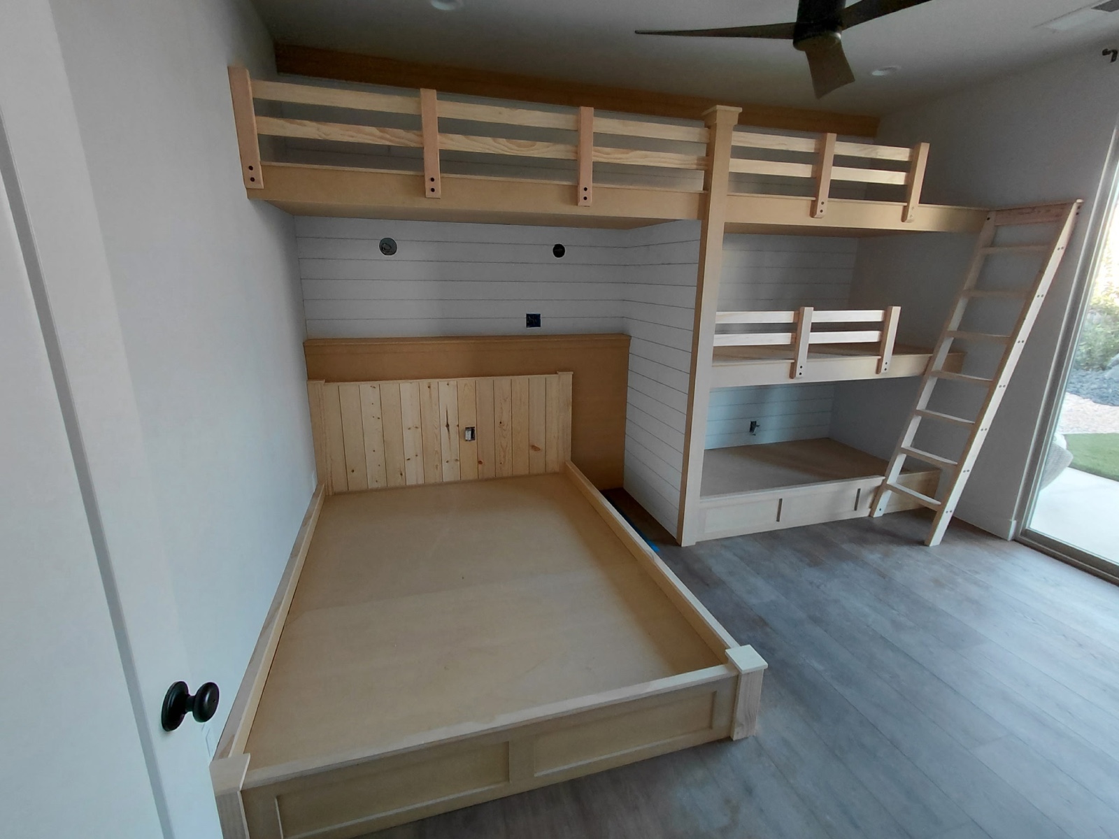 Built-in bunk beds before paint — bare pine framing